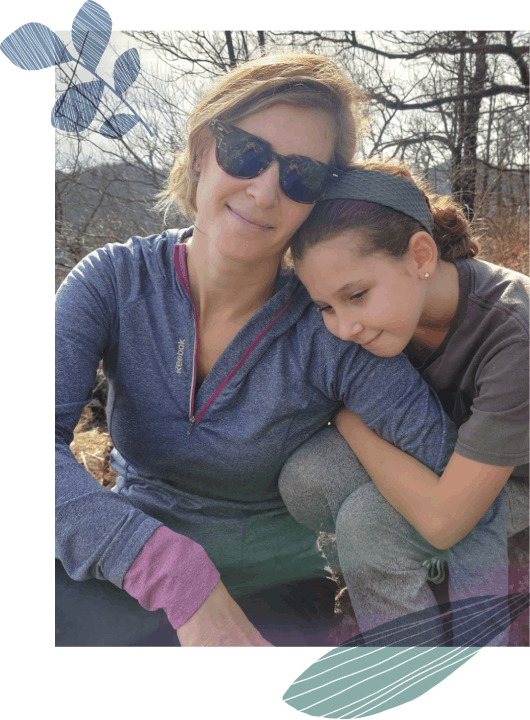 A mother and her daughter sitting hugged